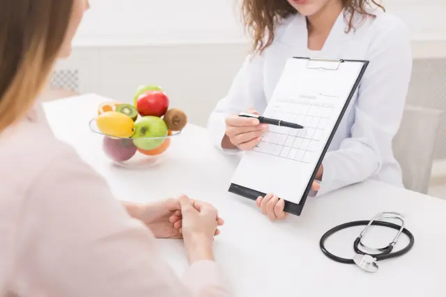 a doctor holding a clipboard and a pen